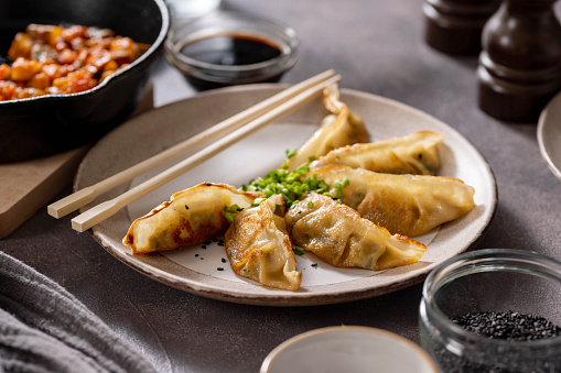 Dumplings gyoza with soy sauce, and chopsticks