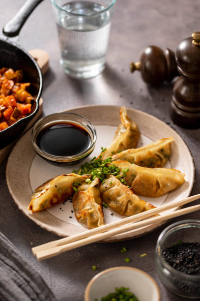 istock Fried dumplings gyoza with soy sauce, and chopsticks. 1475581009