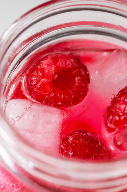 istock Closeup, macro shot of a raspberry refreshing lemonade in mason jar, summer cold drink. 1475581127