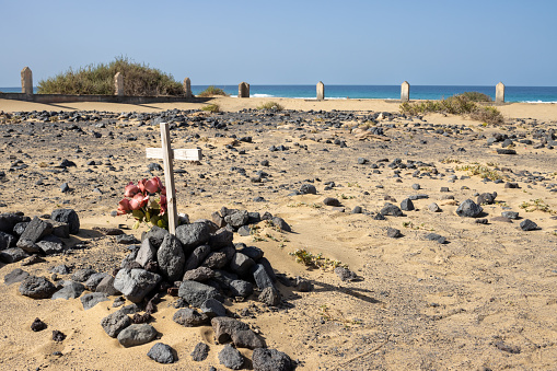 On the Atlantic ocean beach, place which belongs to nobody and everybody, was built a cemetery for local inhabitants. Crosses and tombstones among the sand of the beach. Cofete, Fuerteventura.
