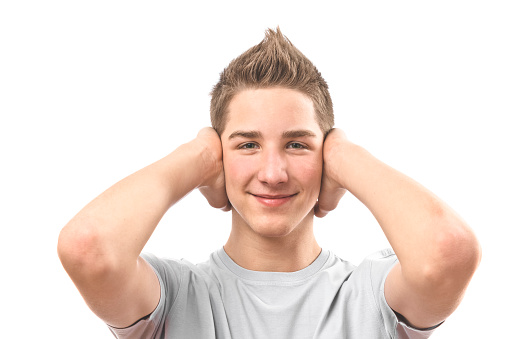 Teenage boy covering his ears