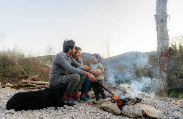 istock Family gathered around the campfire 1475586368