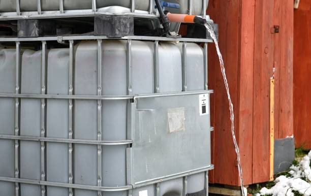 istock Rainy water flowing from a plastic container in the garden before frozen winter 1475587661
