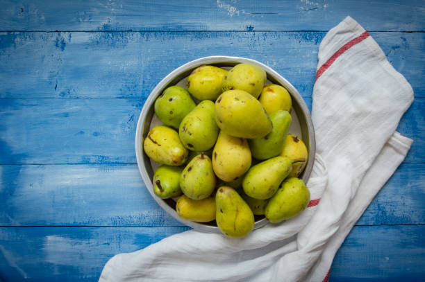 istock Fresh Organic Pears On Wooden Background 1475588739