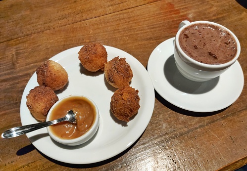 fritter and chocolate in wooden table
