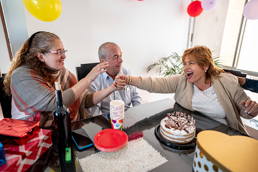 Mature woman celebrating her birthday with friends