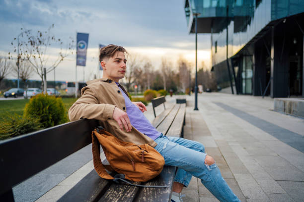 istock Man sitting on the city bench 1475593559