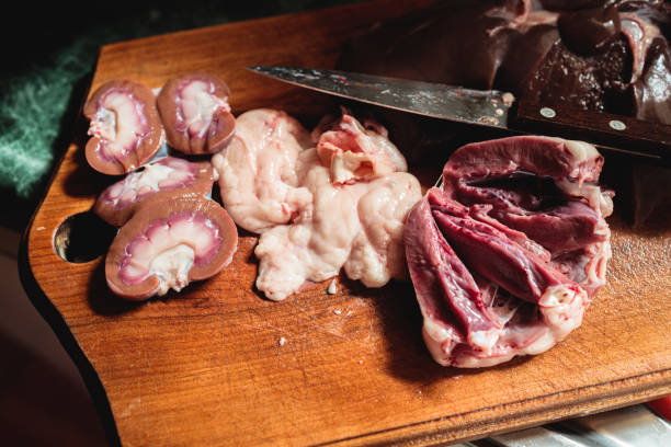 Raw sliced kidneys, heart and testicles of a lamb, ready to be cooked. Viscera, entrails and bowels preparation. stock photo
