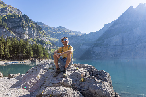 Berner Oberland canton, Switzerland
He sits on a rock by a beautiful blue lake in the center of Switzerland.