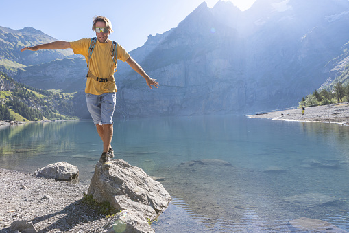 Berner Oberland canton, Switzerland
He jumps from rock to rock by a beautiful blue lake in the center of Switzerland.