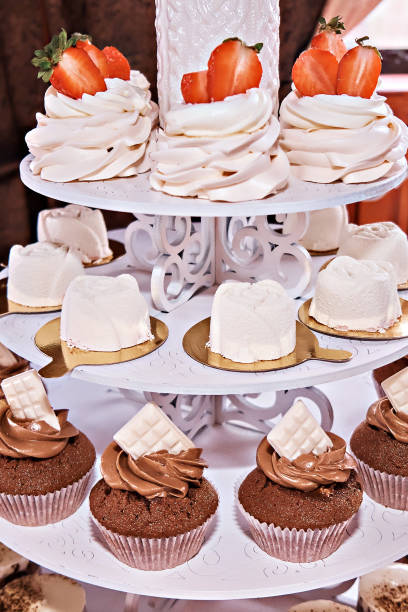 istock Cupcakes with different fillings are laid out vertically. Banquet table. 1475597639