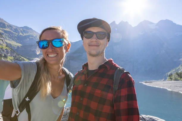 istock Two people take selfie while hiking around beautiful alpine lake 1475599442
