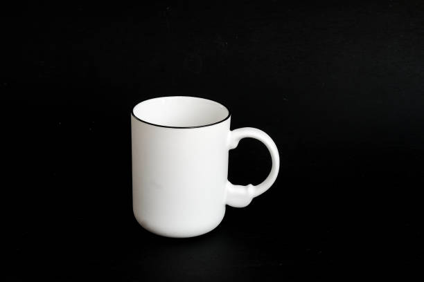istock White mug. White cup with red heart for tea or coffee on background. 1475602287