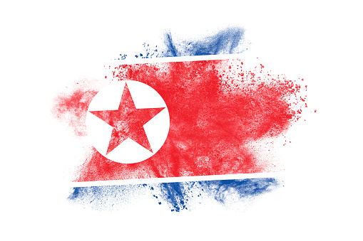 Abstract exploding flag of North Korea on white background.