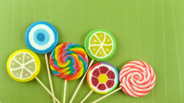 istock Colorful lollipops on green background 1475603963