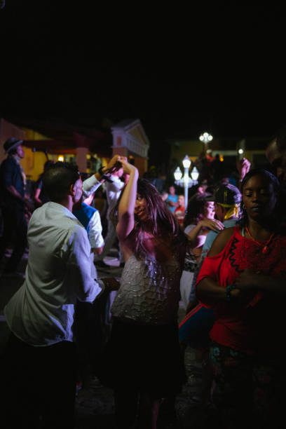 Trinidad, Cuba - December 6, 2014: A couple dances salsa late at night outdoors near the main square in Trinidad, Cuba