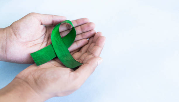 istock Holding Green awareness ribbon 1475605298