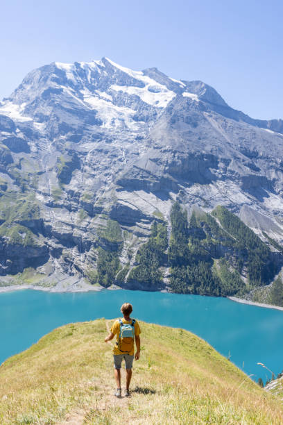 istock Hiker against the mountains, he enjoys nature 1475607269