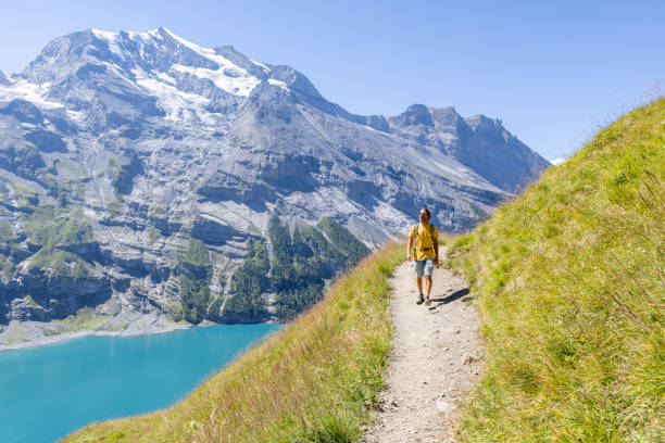 istock Front view of hiker in the mountains following the walking path 1475609208