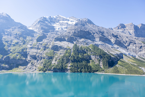 Berner Oberland canotn, Switzerland\nA spectacular alpine lake in the center of Switzerland, pine trees, glaciers and blue lake