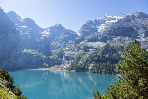 Berner Oberland canotn, Switzerland\nA spectacular alpine lake in the center of Switzerland, pine trees, glaciers and blue lake