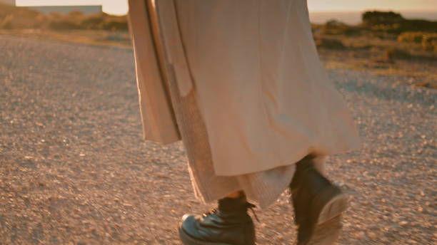 istock Hipster legs going road at seaside closeup. Peaceful woman walking in sunlight 1475615346