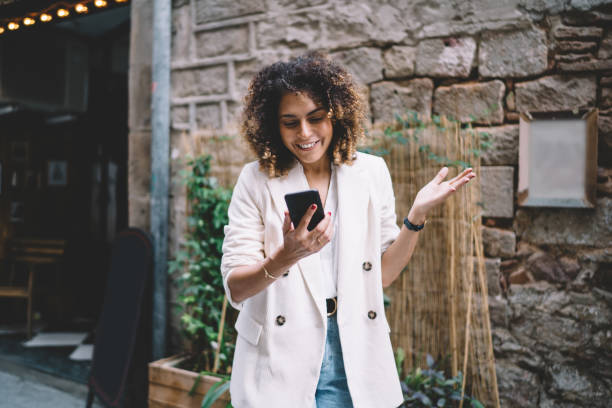 istock Happy Caucaisan woman in trendy clothing reading text message received on cellular technology, cheerful hipster girl enjoying mobile chatting using application for making online web booking 1475615794