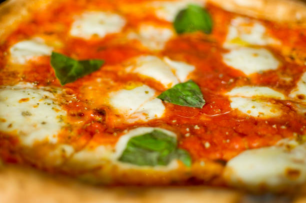 istock A pizza margherita triangle close up. Selective focus. 1475617063