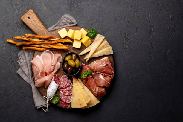 istock Antipasto board with various meat and cheese snacks 1475617593
