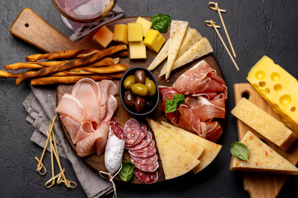 Antipasto board with various meat and cheese snacks Antipasto board with various meat and cheese snacks. Flat lay appetizer plate stock pictures, royalty-free photos & images