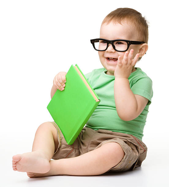 istock Little child play with book 147561786