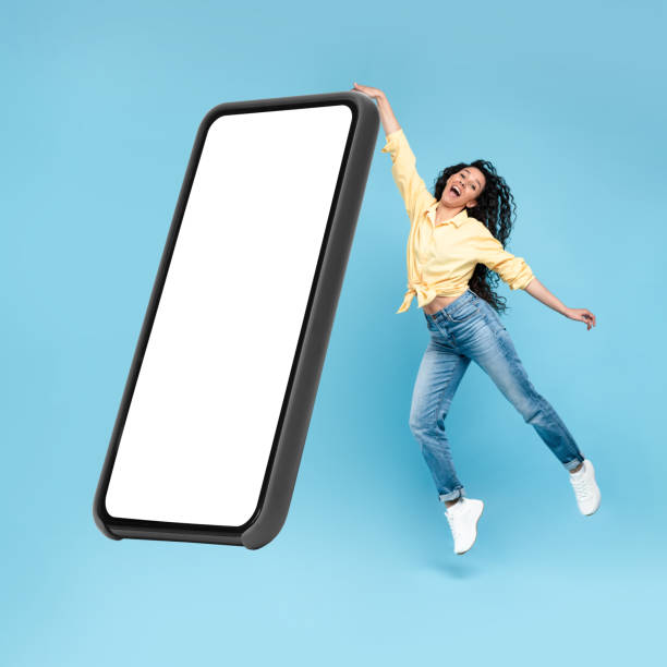 istock Excited lady showing white empty smartphone screen and jumping 1475624209