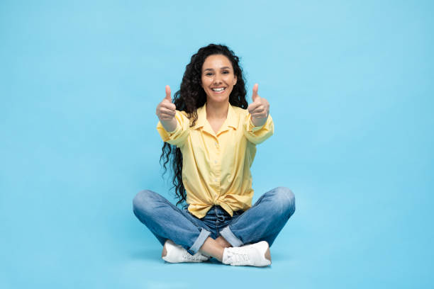 istock Arabic Woman Gesturing Thumbs Up With Both Hands, Blue Background 1475624397