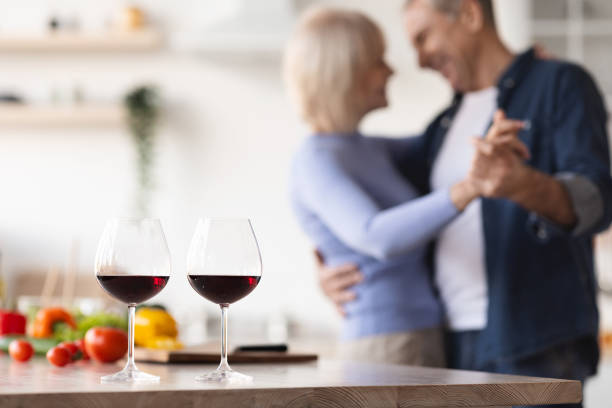 istock Two glasses of red wine on kitchen table 1475624581