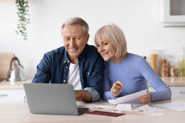 istock Happy pensioners sittting in front of computer, reading emails 1475624608