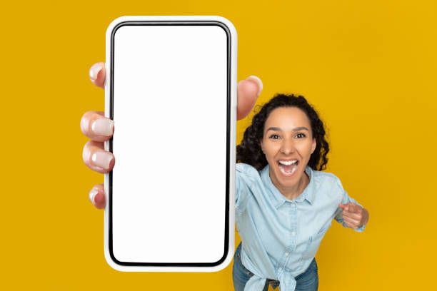istock Excited woman showing blank mobile phone screen at studio 1475624722