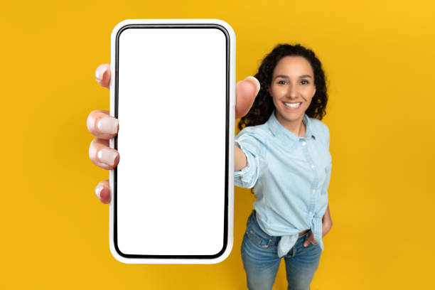 istock Woman showing white empty smartphone screen close to camera 1475624727