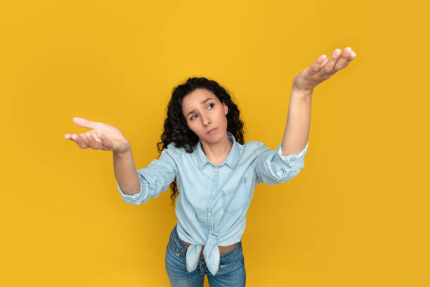 istock Pensive young woman comparing variants, making scales with empty hands 1475624730
