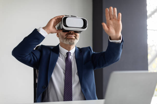 istock Modern Technologies. Excited Middle Aged Businessman Using VR Glasses In Office 1475624823
