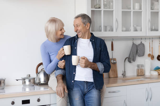 istock Cheerful elderly spouses enjoying time together, drinking coffee 1475625118