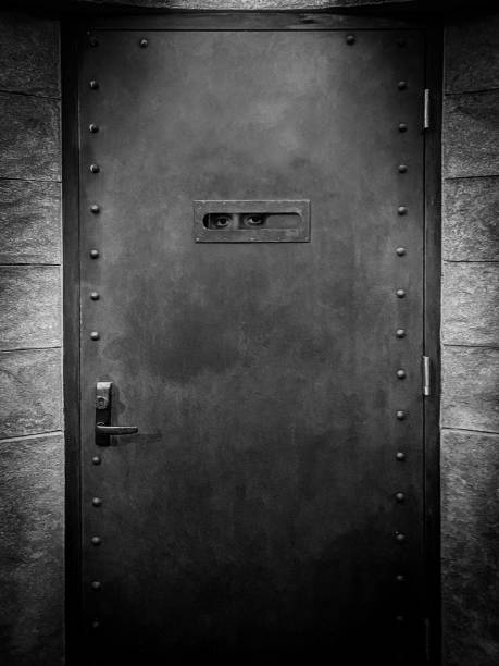 Speakeasy door entrance Eerie door entrance to a speakeasy with eyes peeping through door peep hole peep hole stock pictures, royalty-free photos & images