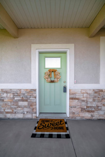 istock Utah- Light green front door with blue lockbox and window panel with wreath below 1475627154