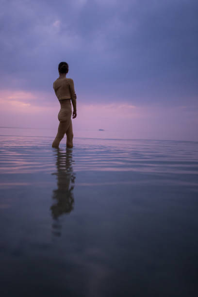 istock Woman enjoying calm sea 1475628763