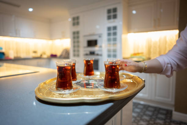 Woman hand holding Turkish tea for drink