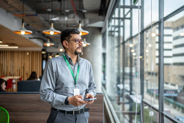istock Mature man looking away contemplating at office 1475632141