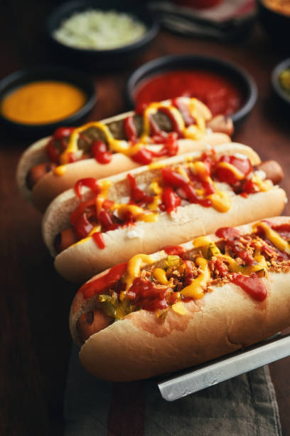 Hot Dog with Roasted Onions, Pickle Relish, Mustard and Ketchup stock photo