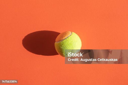 istock Beach tennis ball on orange color background. Horizontal sport poster, greeting cards, headers, website 1475633814