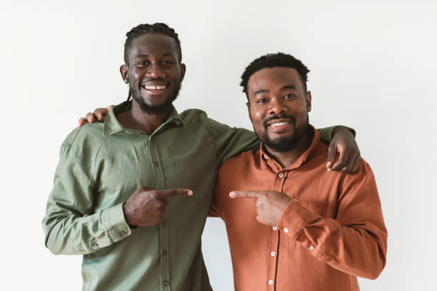 istock Two African Men Pointing Fingers At One Another, White Background 1475634254
