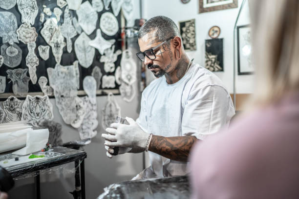istock Tattoo artist preparing to tattoo a customer at a tattoo studio 1475637074