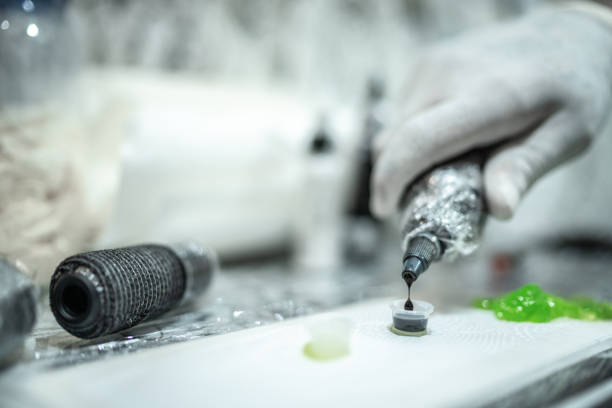 Tattoo artist's hand preparing ink to tattoo at a tattoo studio